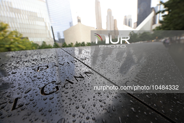 Flowers and US flags are laid on one of the North Pool panels at World Trade Center Memorial to commemorate the 9/11 Anniversary in New York...