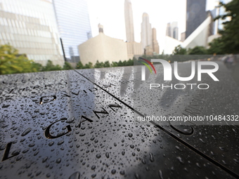 Flowers and US flags are laid on one of the North Pool panels at World Trade Center Memorial to commemorate the 9/11 Anniversary in New York...