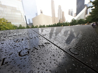 Flowers and US flags are laid on one of the North Pool panels at World Trade Center Memorial to commemorate the 9/11 Anniversary in New York...