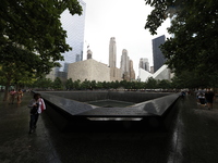 Flowers and US flags are laid on one of the North Pool panels at World Trade Center Memorial to commemorate the 9/11 Anniversary in New York...