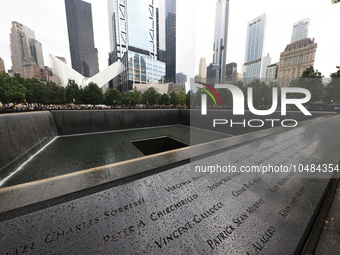 Flowers and US flags are laid on one of the North Pool panels at World Trade Center Memorial to commemorate the 9/11 Anniversary in New York...