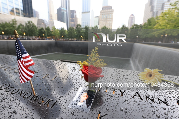 Flowers and US flags are laid on one of the North Pool panels at World Trade Center Memorial to commemorate the 9/11 Anniversary in New York...