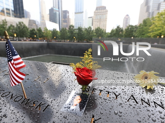 Flowers and US flags are laid on one of the North Pool panels at World Trade Center Memorial to commemorate the 9/11 Anniversary in New York...