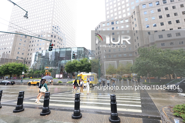 Pedestrians cross West Side to Brookfield Place across from the World Trade Center Memorial site and One World Trade Center in New York, New...