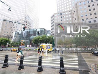 Pedestrians cross West Side to Brookfield Place across from the World Trade Center Memorial site and One World Trade Center in New York, New...