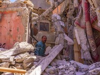 A man is searching for his belongings in what remains of his house in the city of Amizmiz, located just a few dozen kilometers from the epic...