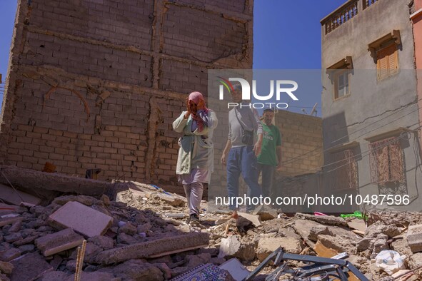 A family walks amidst the rubble in the city of Amizmiz, after being stranded due to the earthquake that destroyed their home. Amizmiz is lo...