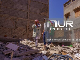 A family walks amidst the rubble in the city of Amizmiz, after being stranded due to the earthquake that destroyed their home. Amizmiz is lo...