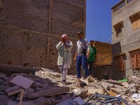 A family walks amidst the rubble in the city of Amizmiz, after being stranded due to the earthquake that destroyed their home. Amizmiz is lo...