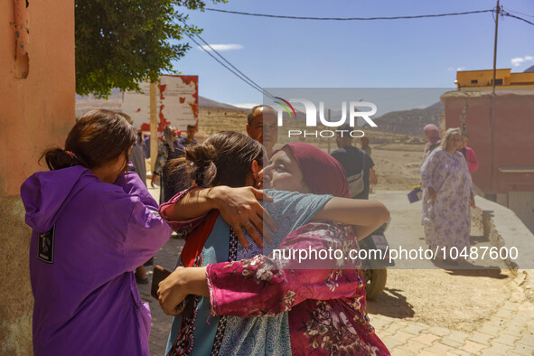 Two friends embrace each other after the earthquake destroyed their homes in Amizmiz, just a few dozen kilometers from the epicenter of the...