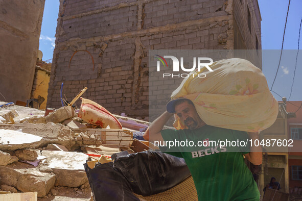 A man retrieves blankets from his destroyed house in Amizmiz, just a few dozen kilometers away from the epicenter of the earthquake that sho...