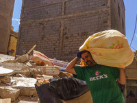 A man retrieves blankets from his destroyed house in Amizmiz, just a few dozen kilometers away from the epicenter of the earthquake that sho...