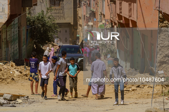 A group of young people walks along the main road amidst the rubble in Amizmiz, just a few dozen kilometers from the epicenter of the earthq...