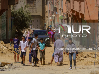 A group of young people walks along the main road amidst the rubble in Amizmiz, just a few dozen kilometers from the epicenter of the earthq...