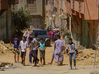 A group of young people walks along the main road amidst the rubble in Amizmiz, just a few dozen kilometers from the epicenter of the earthq...