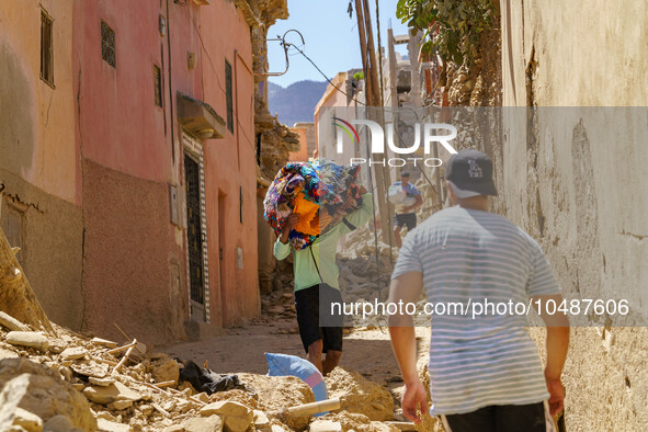 A man retrieves blankets from his destroyed house in Amizmiz, just a few dozen kilometers away from the epicenter of the earthquake that sho...