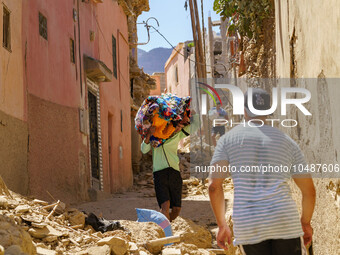 A man retrieves blankets from his destroyed house in Amizmiz, just a few dozen kilometers away from the epicenter of the earthquake that sho...