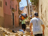 A man retrieves blankets from his destroyed house in Amizmiz, just a few dozen kilometers away from the epicenter of the earthquake that sho...