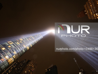 The Tribute in Light rises above the New York City skyline from the rooftop of where the installation was projected to commemorate the 9/11...