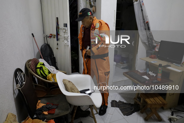 Hector Mendez, better known as El Chino, head and founder of the Azteca Topos International Rescue Brigade, gets ready at his home before tr...