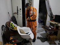 Hector Mendez, better known as El Chino, head and founder of the Azteca Topos International Rescue Brigade, gets ready at his home before tr...