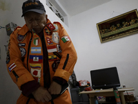 Hector Mendez, better known as El Chino, head and founder of the Azteca Topos International Rescue Brigade, gets ready at his home before tr...