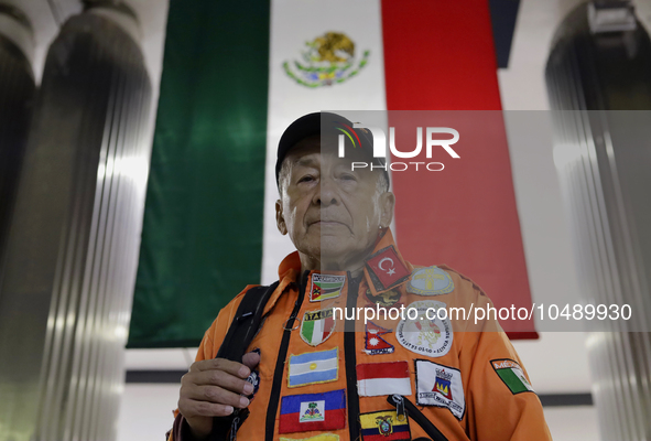 Hector Mendez, better known as El Chino, head and founder of the Azteca Topos International Rescue Brigade, in front of a Mexican flag insid...