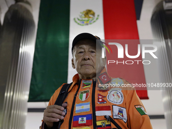 Hector Mendez, better known as El Chino, head and founder of the Azteca Topos International Rescue Brigade, in front of a Mexican flag insid...