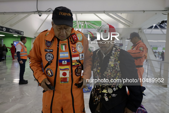 Hector Mendez (l), better known as El Chino, head and founder of the Azteca Topos International Rescue Brigade, arrives at the Mexico City I...