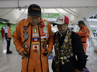 Hector Mendez (l), better known as El Chino, head and founder of the Azteca Topos International Rescue Brigade, arrives at the Mexico City I...