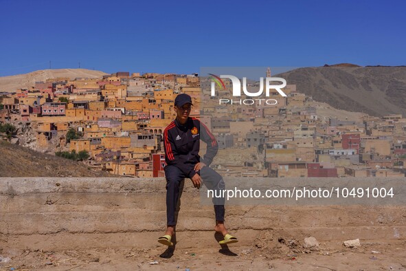 A young man sits on a wall in the village of Mulay Brahim, a few kilometres from the epicenter of the hearthquake 