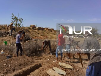 A group of men is digging graves for the earthquake victims in the village of Tafeghaghte. (