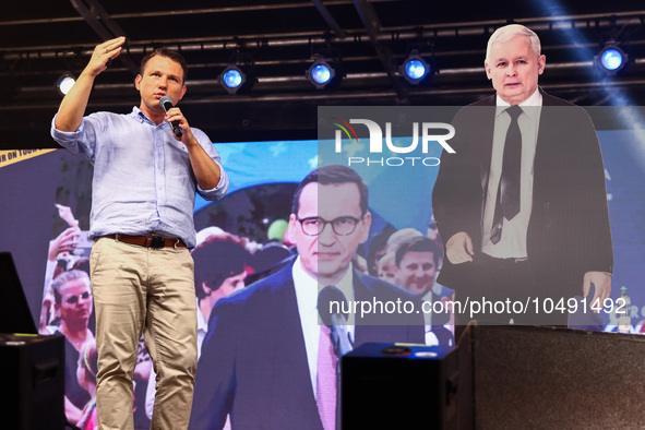 Co-leader of the Confederation Liberty and Independence party (Konfederacja), Slawomir Mentzen, speaks standing next to paper cut Jaroslaw K...