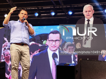 Co-leader of the Confederation Liberty and Independence party (Konfederacja), Slawomir Mentzen, speaks standing next to paper cut Jaroslaw K...