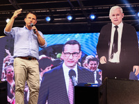 Co-leader of the Confederation Liberty and Independence party (Konfederacja), Slawomir Mentzen, speaks standing next to paper cut Jaroslaw K...