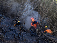 Some of officers shot water to the remaining fires on the slopes of the mountain that occurred since mid-August during the dry season in the...