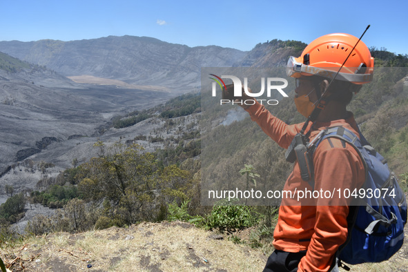 Some of  officer monitors hotspots on the slopes of a mountain that have been burning since mid-August during the dry season in the Bromo Te...