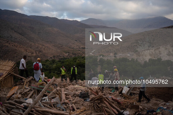 A foreign rescue ream probes debris of a cluster of houses in search of survivors and earthquake victims' bodies in the village of  Imi N'Ta...