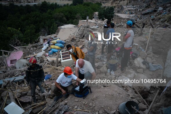 A foreign rescue team inspects the rubble of the houses destroyed by the earthquake in the village of Imi N'Tala, located 75 kilometers sout...