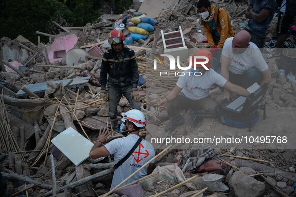 A foreign rescue team inspects the rubble of the houses destroyed by the earthquake in the remoted village of Imi N'Tala, located 75 kilomet...