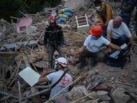 A foreign rescue team inspects the rubble of the houses destroyed by the earthquake in the remoted village of Imi N'Tala, located 75 kilomet...