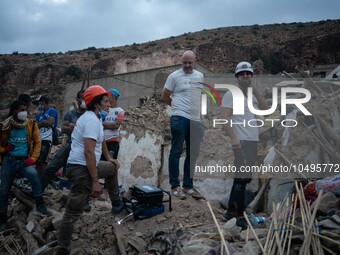 A foreign rescue team inspects the rubble of the houses destroyed by the earthquake in the remoted village of Imi N'Tala, located 75 kilomet...