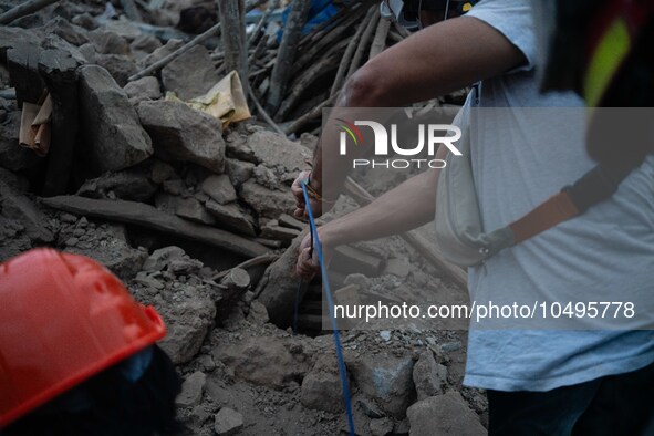 A foreign rescue team digs in search of survivors in the remote village of Imi N'Tala, located 75 kilometers southwest of Marrakesh. 