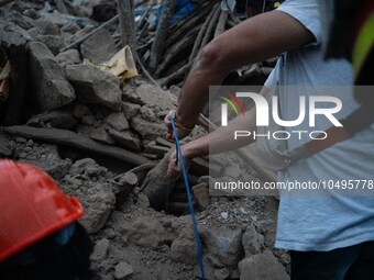 A foreign rescue team digs in search of survivors in the remote village of Imi N'Tala, located 75 kilometers southwest of Marrakesh. (