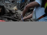 A foreign rescue team digs in search of survivors in the remote village of Imi N'Tala, located 75 kilometers southwest of Marrakesh. (