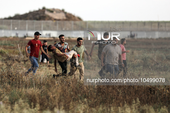 An injured Palestinian protestor is carried away following clashes with Israeli security forces along the Gaza-Israel border east of Gaza Ci...