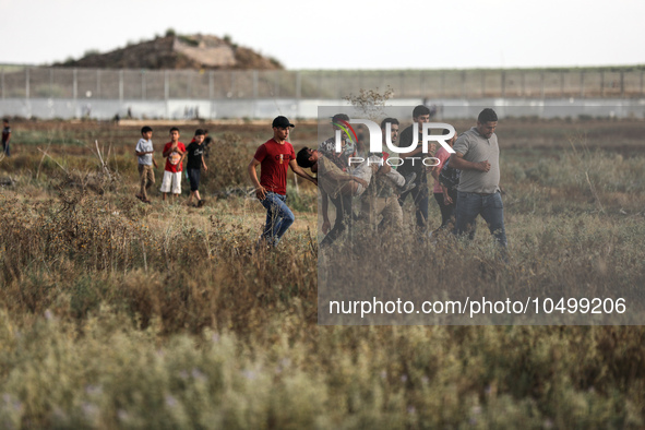 An injured Palestinian protestor is carried away following clashes with Israeli security forces along the Gaza-Israel border east of Gaza Ci...