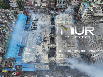 An aerial view shows smoke rises after a massive fire broke out, at the Mohammadpur Krishi Market in Dhaka, Bangladesh, on September 14, 202...