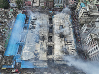 An aerial view shows smoke rises after a massive fire broke out, at the Mohammadpur Krishi Market in Dhaka, Bangladesh, on September 14, 202...