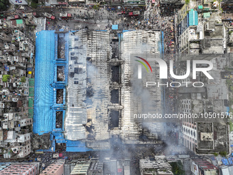 An aerial view shows smoke rises after a massive fire broke out, at the Mohammadpur Krishi Market in Dhaka, Bangladesh, on September 14, 202...